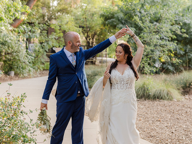 Groom kissing bride at reception at night on the dancefloor